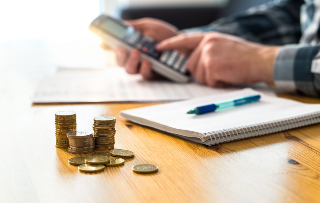 Coins next to accountant and notepad