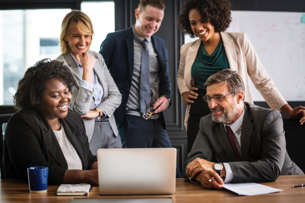 Marketing team around laptop